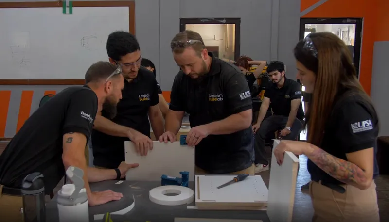 DuckWorks drafters assembling a millwork panel together at a workbench
